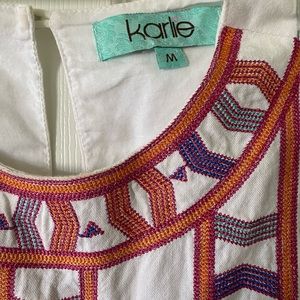 White dress with colorful detailing.